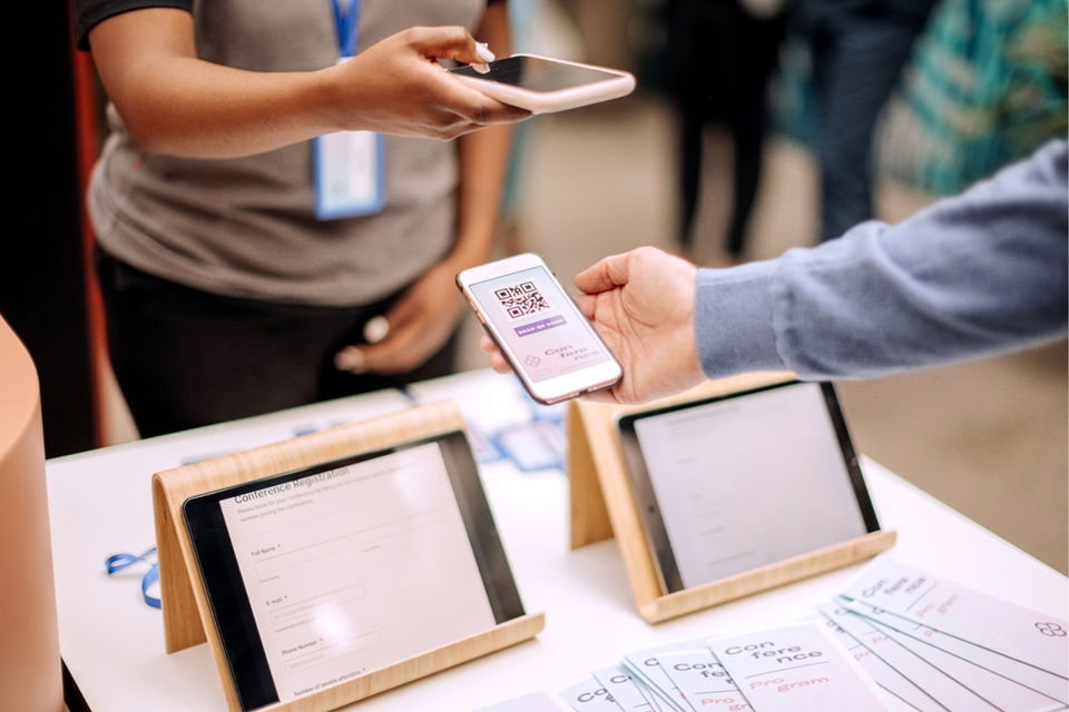 Digital badge scanning staff for San Francisco conferences validating QR codes and supporting mobile attendee check-in during tech and SaaS events.