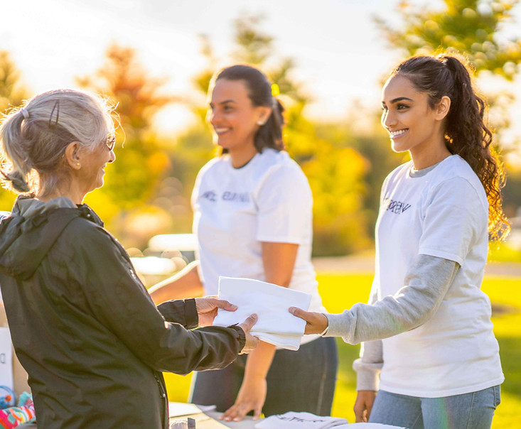 Los Angeles street team representatives distributing promotional materials and speaking with community members during an outdoor awareness campaign. The outreach team helps increase campaign reach, introduce brands to local audiences, and support grassroots marketing activations across Los Angeles.