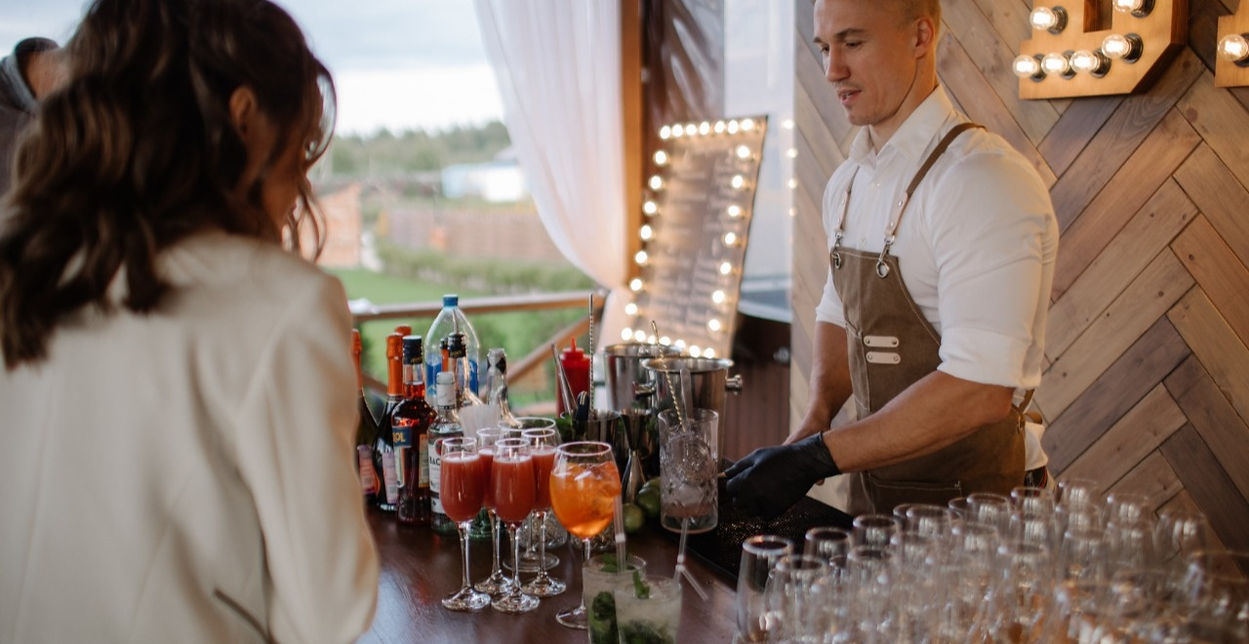 Bartender serving cocktails at a private event in Los Angeles — bar setup with fresh ingredients, glassware, and premium alcohol display for event staffing service.