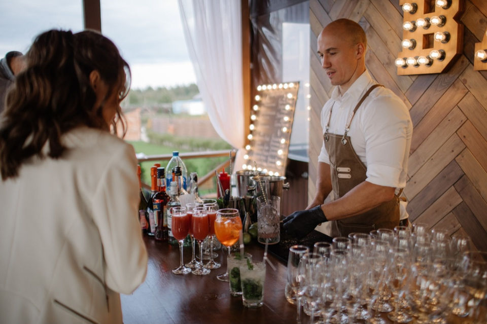 Professional bartender serving signature cocktails during a Las Vegas product launch event. Beverage specialist supporting brand activations, guest engagement, VIP receptions, and experiential marketing events with polished presentation and premium hospitality service.