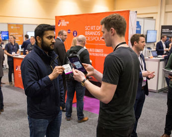 Conference badge verification staff in San Francisco scanning attendee credentials and managing secure access control during trade shows and business expos.
