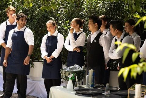 Professional banquet service team preparing for guest service at an outdoor Las Vegas event. Hospitality staff coordinating food and beverage operations, guest support, and event execution for a corporate reception, gala dinner, convention function, or private celebration.
