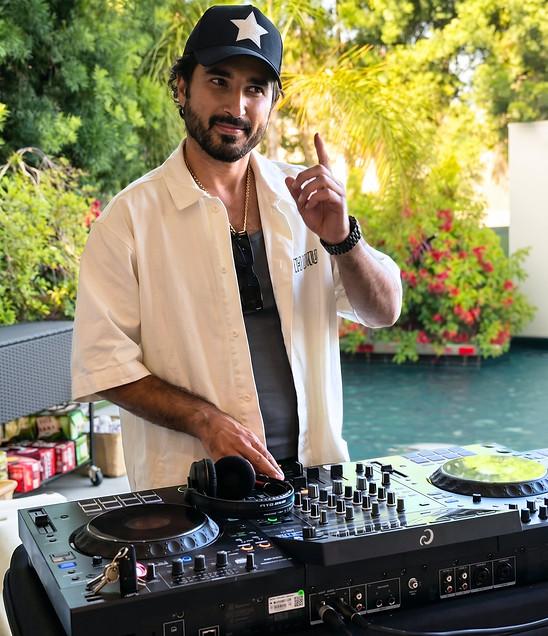 A private party DJ in Los Angeles performs live beside a luxury villa pool using professional DJ equipment to create an unforgettable atmosphere for guests. Los Angeles event DJ providing live music and entertainment for private parties, cocktail receptions, luxury celebrations, VIP gatherings, pool parties, weddings, and outdoor events.