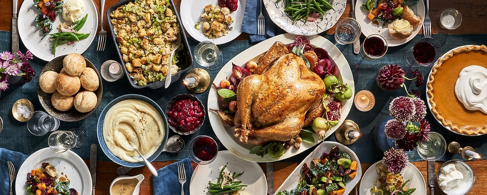 A beautifully arranged Thanksgiving dinner table at a private Los Angeles residence, featuring a golden roasted turkey, mashed potatoes, stuffing, cranberry sauce, rolls, vegetables, and pumpkin pie. Wine glasses and candles add warmth to the holiday atmosphere. This image illustrates the refined service provided by waitstaff and bartenders for Thanksgiving private and residential events in Los Angeles, ensuring each celebration feels elegant, seamless, and stress-free for hosts and guests.