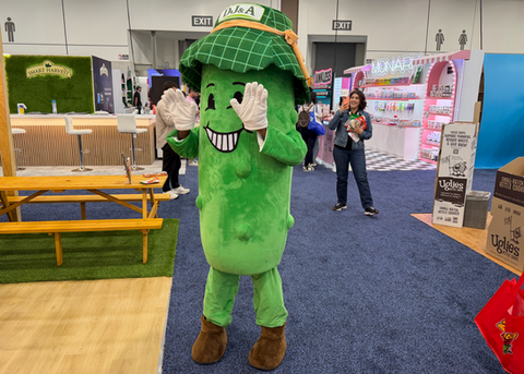 A trade show mascot entertainer in Los Angeles greets attendees inside a convention hall, creating interactive photo opportunities and increasing booth engagement. Mascot entertainment for trade shows helps brands attract visitors, support experiential marketing campaigns, promote products, and boost guest interaction at conventions, expos, and corporate events.