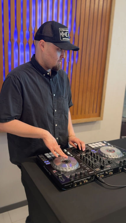 A corporate event DJ in Los Angeles performs during a modern office grand opening using professional DJ equipment to create a welcoming atmosphere for employees, clients, and guests. Corporate DJ services enhance office openings, company celebrations, networking events, ribbon-cutting ceremonies, business receptions, and brand launch events.