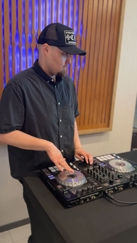 A corporate event DJ in Los Angeles performs during a modern office grand opening using professional DJ equipment to create a welcoming atmosphere for employees, clients, and guests. Corporate DJ services enhance office openings, company celebrations, networking events, ribbon-cutting ceremonies, business receptions, and brand launch events.