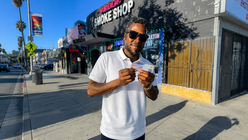 Brand ambassador conducting a QR code street activation in Los Angeles for an EV-based registration campaign, engaging pedestrians during a promotional outreach event in West Hollywood as part of a live experiential marketing activation.