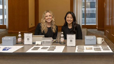 Conference registration attendants managing attendee check-in and badge pickup at a San Francisco business summit near Moscone Center. Registration desk setup for corporate conferences, executive networking events, SaaS expos, and technology summits in SoMa with conference staffing support, guest registration services, badge verification operations, and attendee flow management.