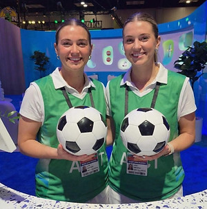San Francisco brand ambassadors engaging attendees at a Bay Area trade show booth, supporting visitor interaction, product awareness, and conference-floor engagement during a consumer technology and sports-focused industry event.