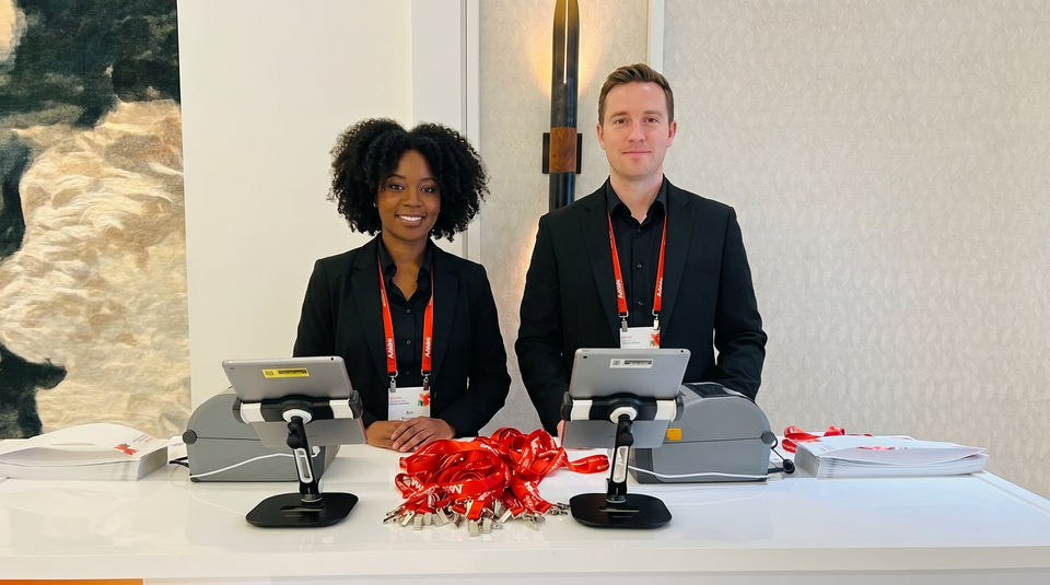 Biotech conference registration staff in San Francisco handling attendee check-in, badge verification, and healthcare event guest registration operations.