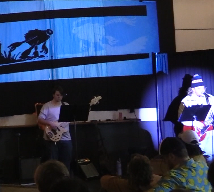 Nik Baumert playing guitar and singing 'Footprints' as the Yeti in a scene from Monstersongs.