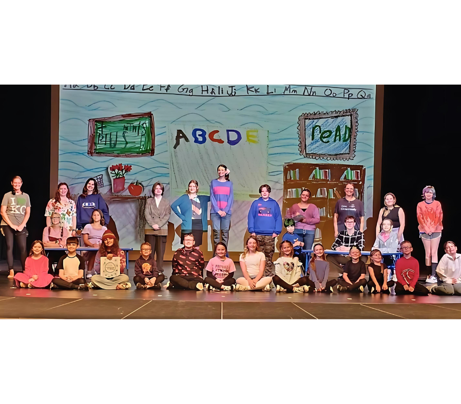 Cast photo of Junie B. Jones is Not a Crook with the actors in colorful school attire, smiling and energetic.