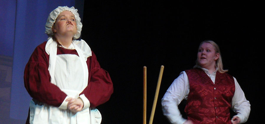 Mrs. Brill makes an exaggerated frown while Robertson Ay stands nearby, talking to her.