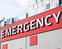 The large EMERGENCY sign outside a hospital.