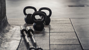 Kettlebells and barbells on a gym floor