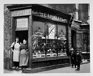 Restored vintage photo of two shopkeepers standing in the doorway