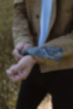 A Person turning up the cuff on a jacket to reveal printed fabric inside