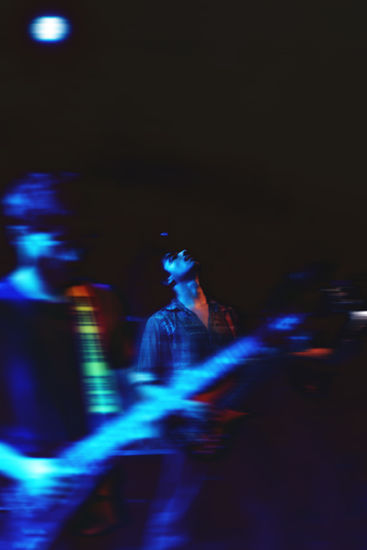 a blurry photo of a man in a blue light