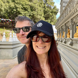 Couple taking a selfie in front of historic architecture in Europe.