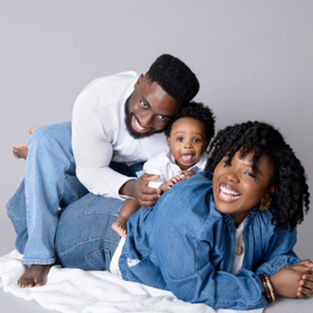 Parents and young child smiling together during a family portrait session at Babyfaces Photography in Pleasanton, California.