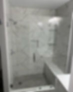 Marble tile shower with glass enclosure