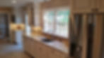 Kitchen with white cabinets, window, and sink