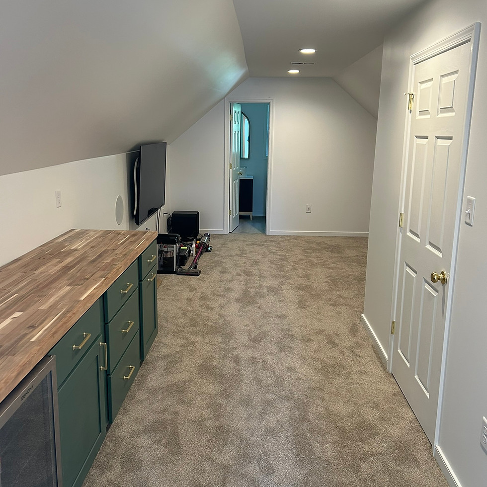 Finished attic hallway with vaulted ceiling, recessed lighting, built-in wood countertop cabinetry, and carpet flooring