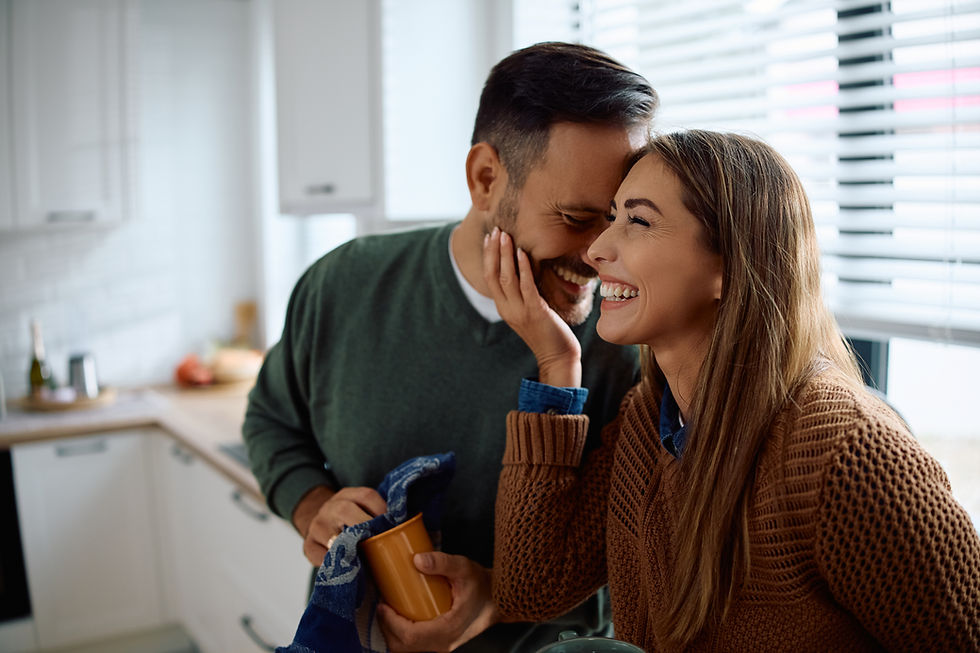 Carefree couple having fun while doing dishes in the kitchen.jpg