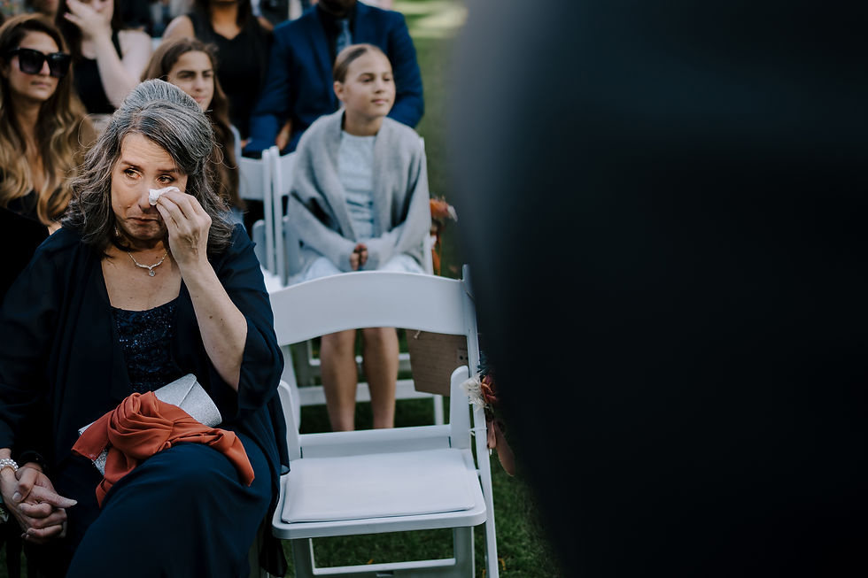 Mother of the groom crying during the ceremony.