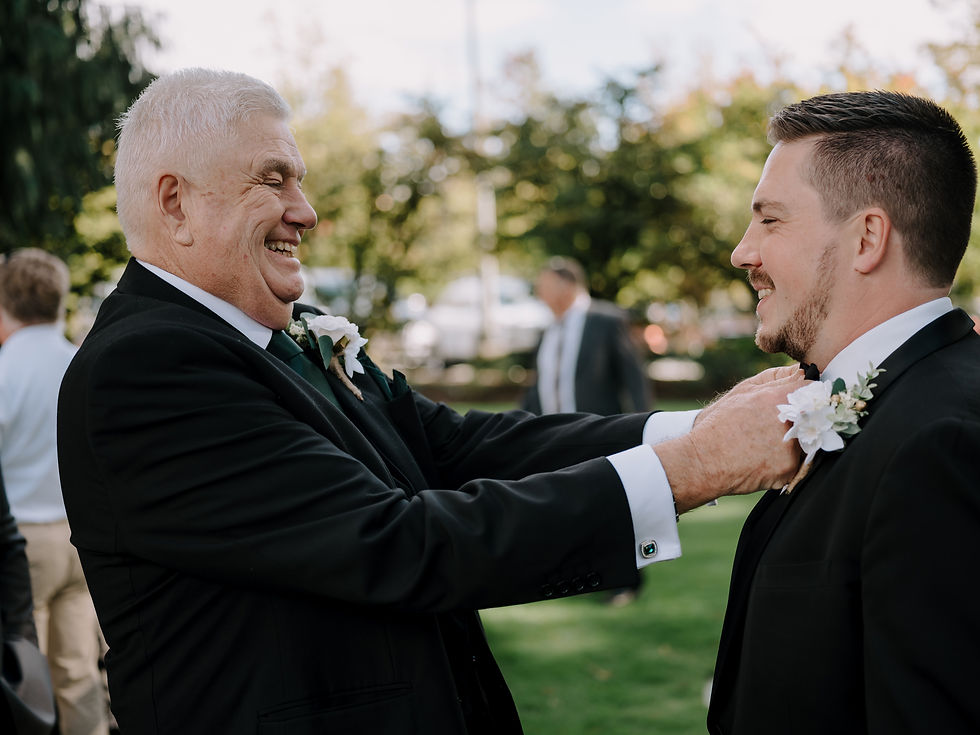 Groom Getting Ready before the ceremony with his father doing some final touch ups.