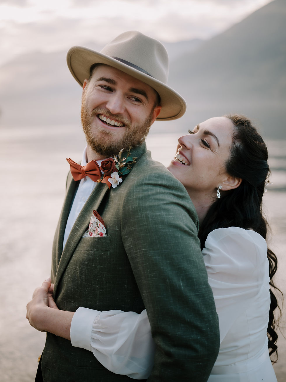 Wedding couple on Gambier Island during the sunset and ocean as their backdrop with more islands in the background.