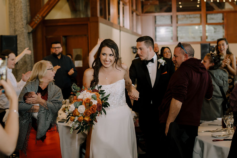 The newly weds walking into their reception.