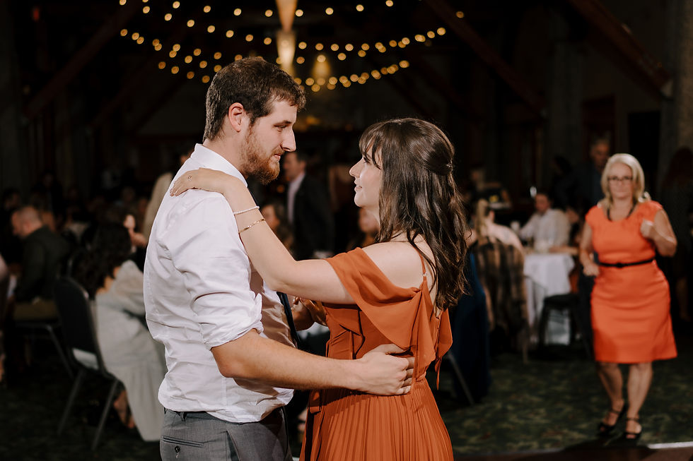 Guest Dancing: Slow dancing guest during the reception under the warm lighting of the Country Club.