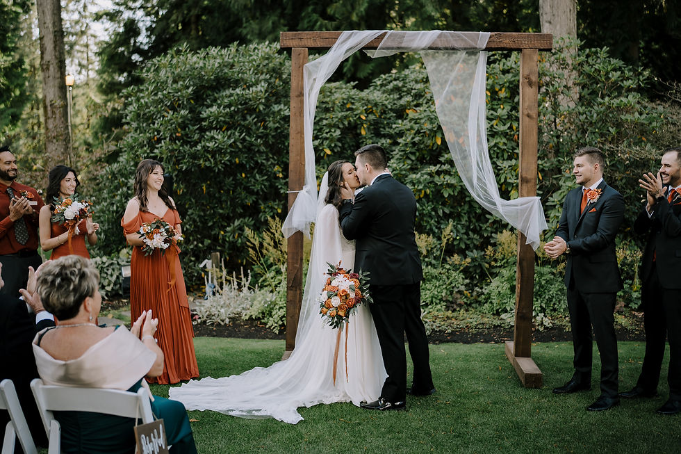 Ceremony image: The first kiss during the ceremony and everyone cheering for the newly weds.