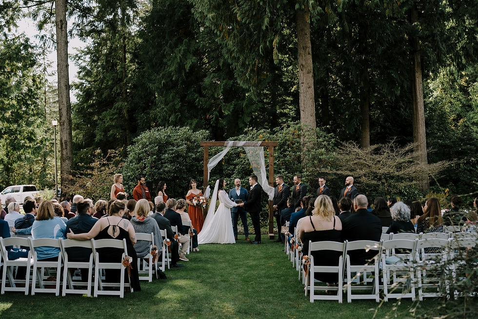 Ceremony Setup: Outdoor wedding ceremony at Westwood Plateau Golf & Country Club, surrounded by trees and vibrant flower gardens in fall colors.