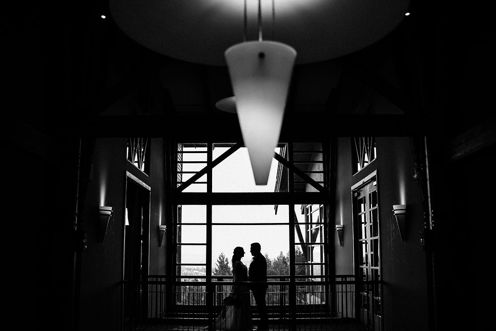 Close-Up of Intimate Moment: Bride and groom sharing a quiet, intimate moment inside the club. Creative silhouette image of the couple.