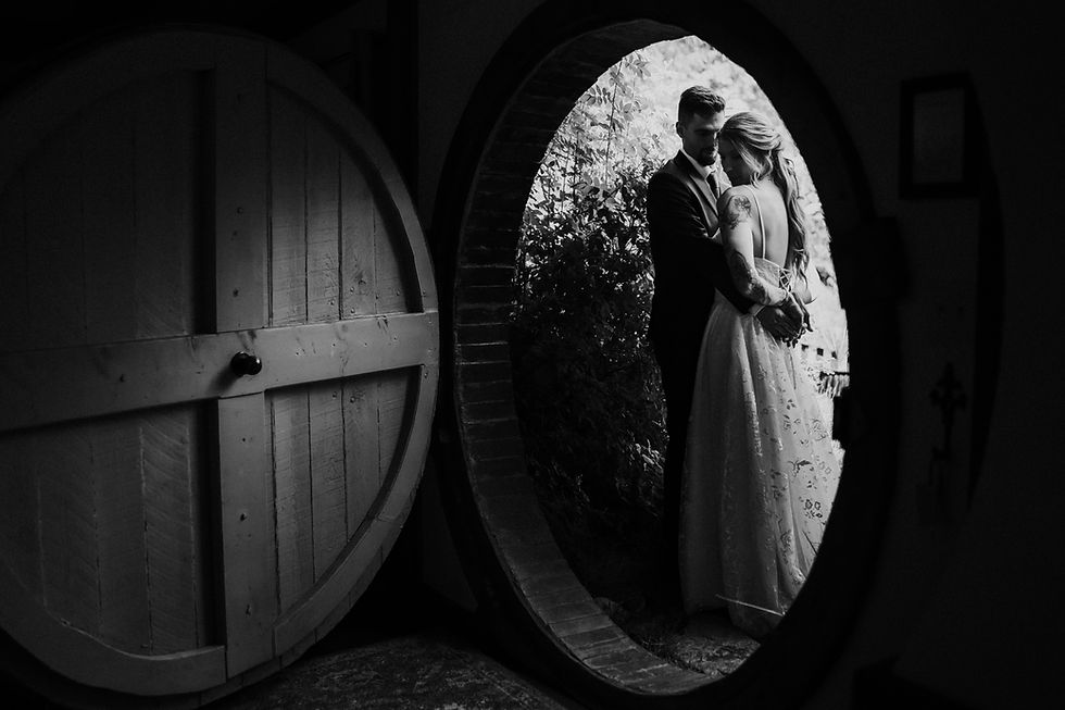 Moody portrait of the couple in front of the Hobbit house door way. Black and White image. Lord of the rings inspired moody, intimate wedding