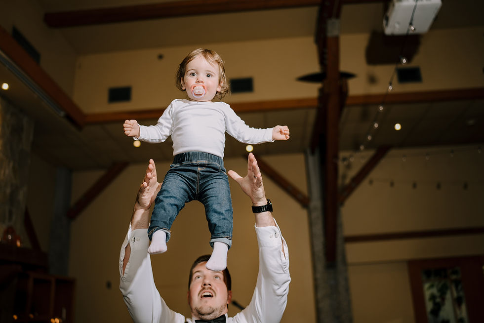 Father daughter moment during the reception. A classic dad move throwing your daughter/son into the air.
