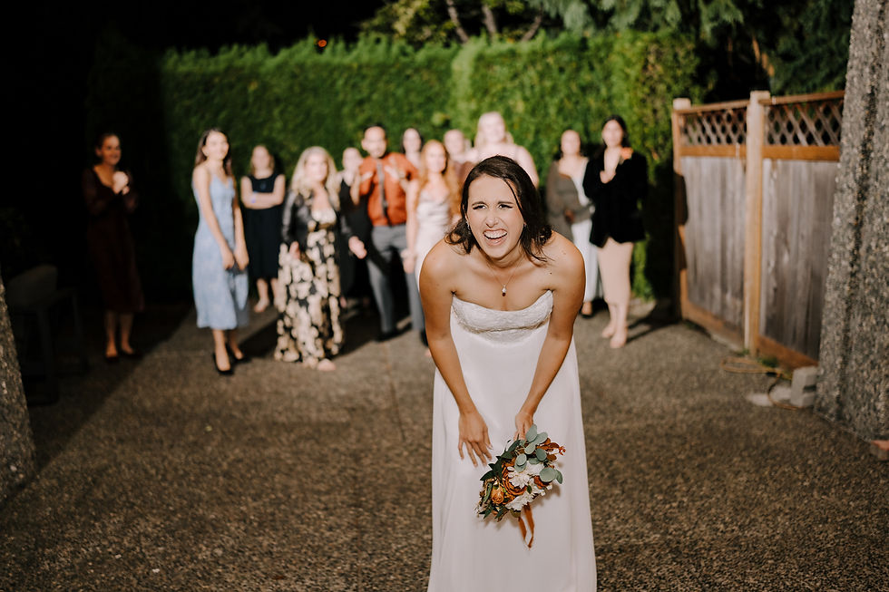Bouquet Toss: Bride laughing before tossing her bouquet into the air, with a group of eager guests reaching to catch it.