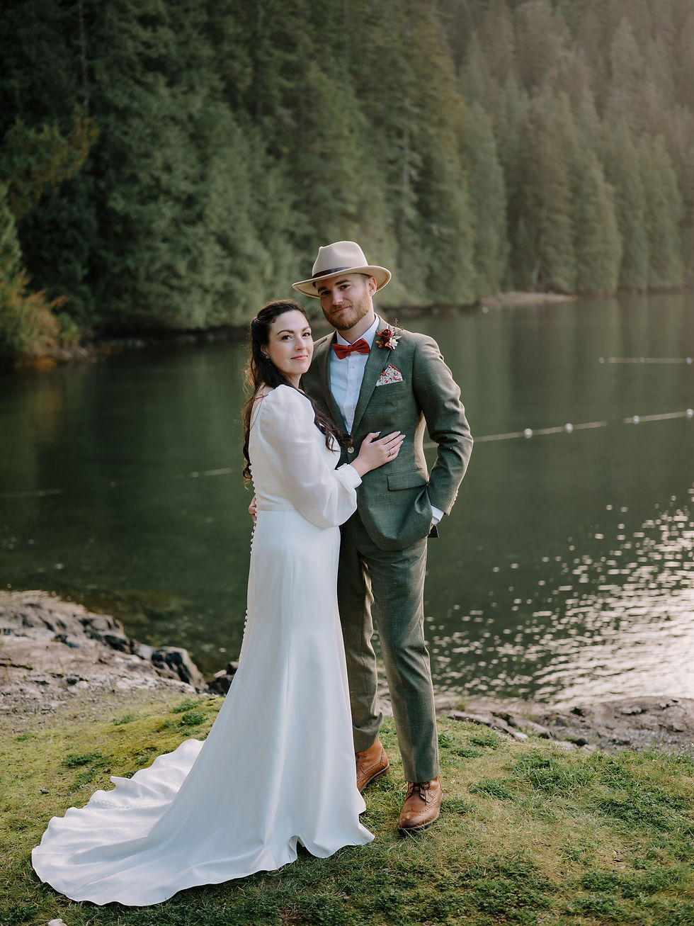 Wedding couple on Gambier Island portraits during the sunset. Ocean and forest as their background.