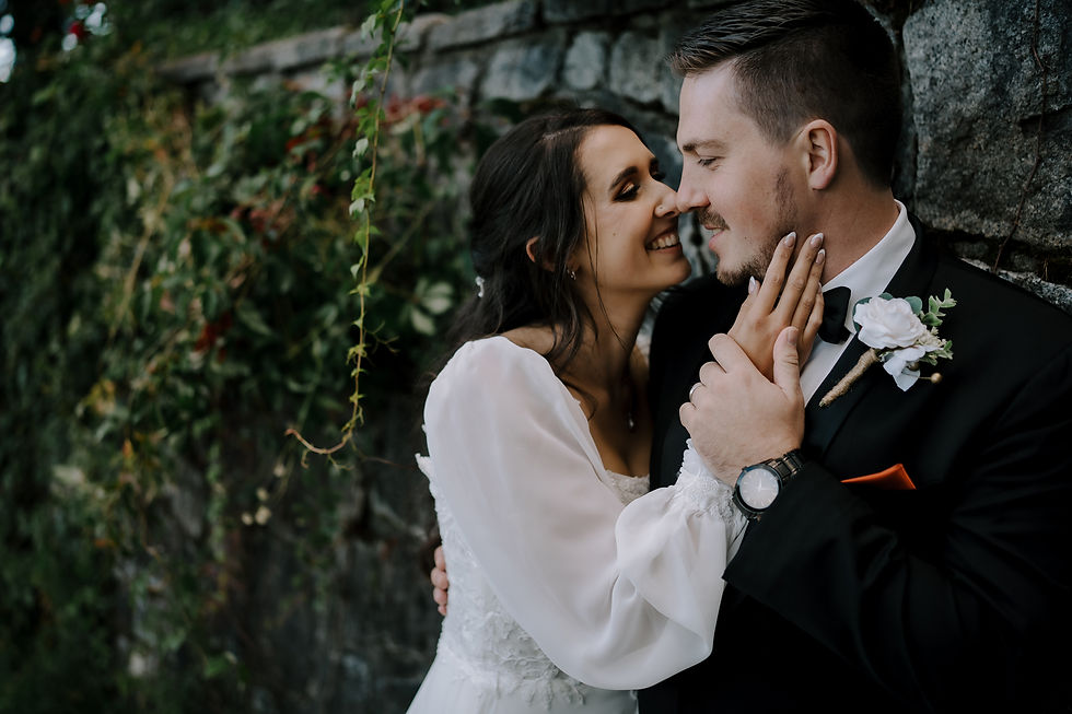 Close-Up of Intimate Moment: Bride and groom sharing a quiet, intimate moment in front of a forested backdrop.