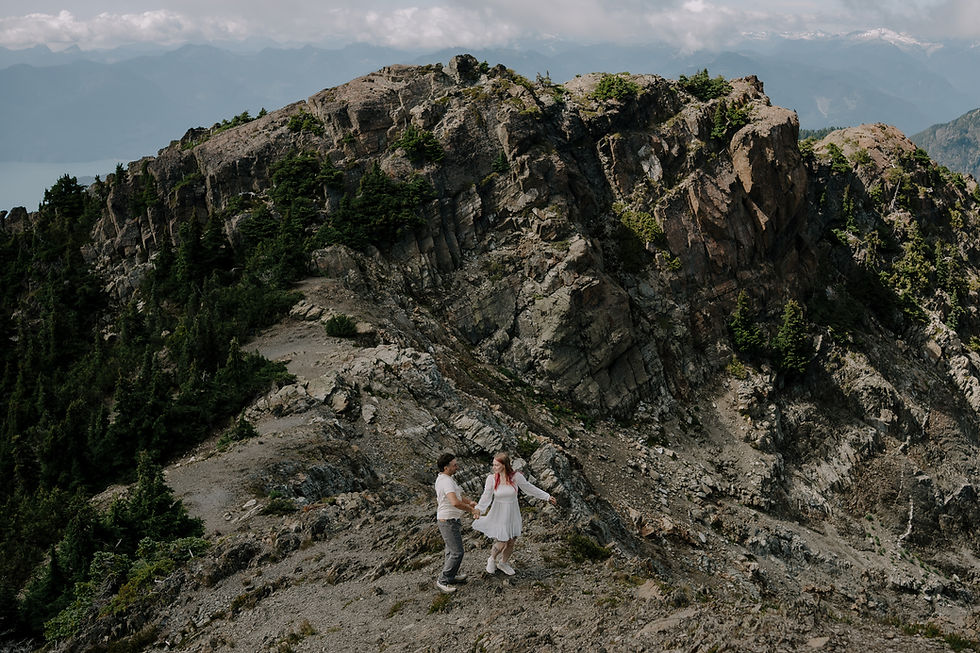 wide view of Brianna and Nick holding hands on the Mount Brunswick trail. Climbing to the top. Moody, adventure, intimate wedding photography