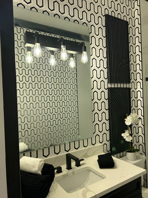 designed bathroom with mirror and vanity