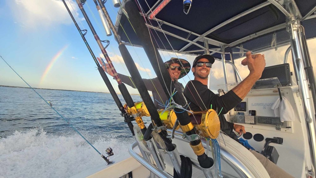 two men enjoying fishing on a boat