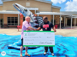 men shaking hands with large check