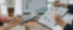 Eye-level view of a calculator and financial documents on a desk