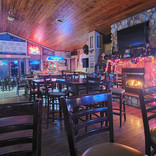 Cozy indoor seating area in the Big Lake Shores lounge with comfortable chairs and warm lighting.
