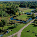 Scenic aerial view of the natural landscape and water features at Big Lake Shores campground.

