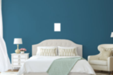 image of a bed with a standard piece of paper in the center of the wall above the bed.